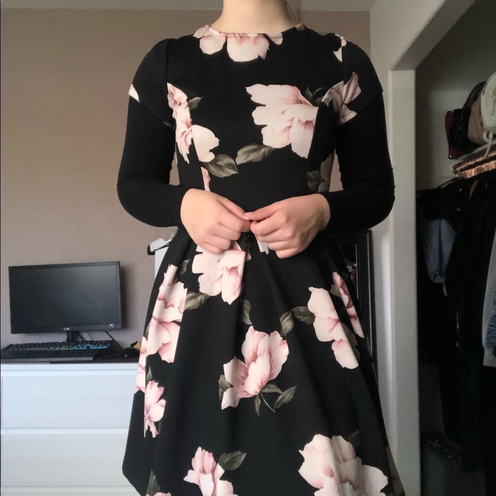 Black backless midi dress with floral print.